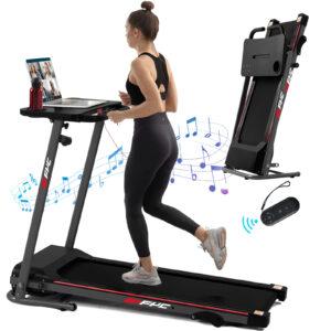 Woman running on foldable treadmill with laptop.