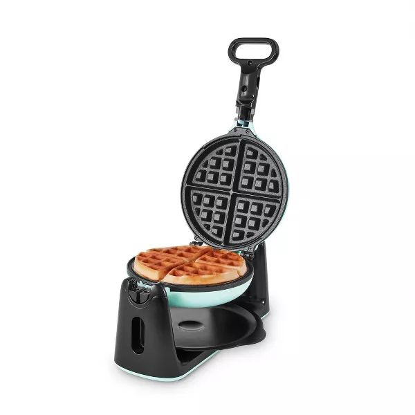 Open waffle maker with cooked waffles inside.