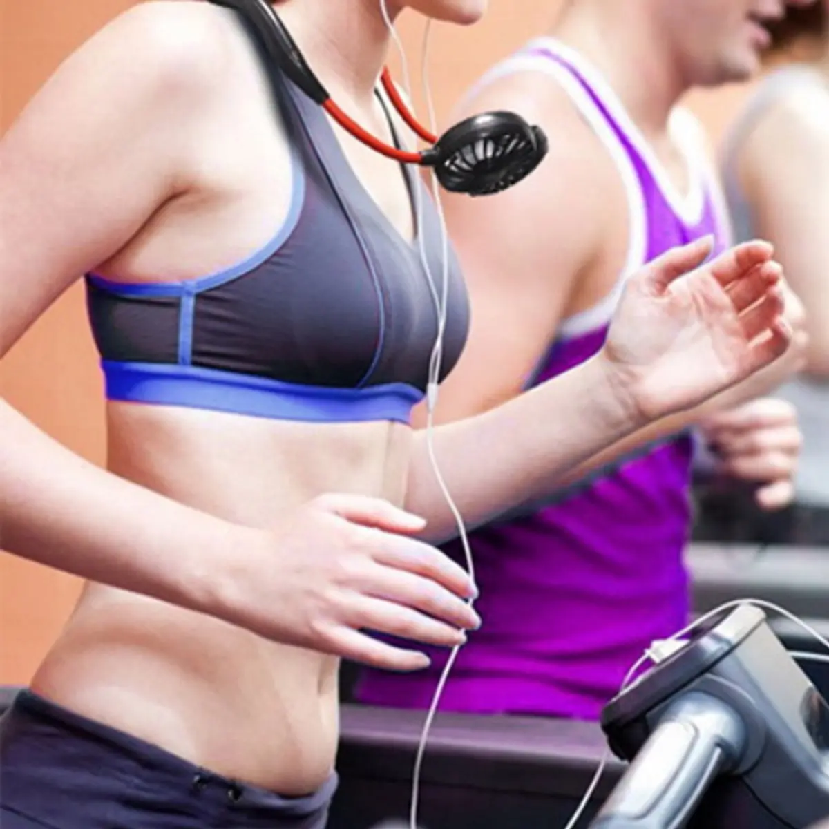 Woman running on treadmill with neck fan