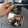 Phone holder attached to airplane seat back.