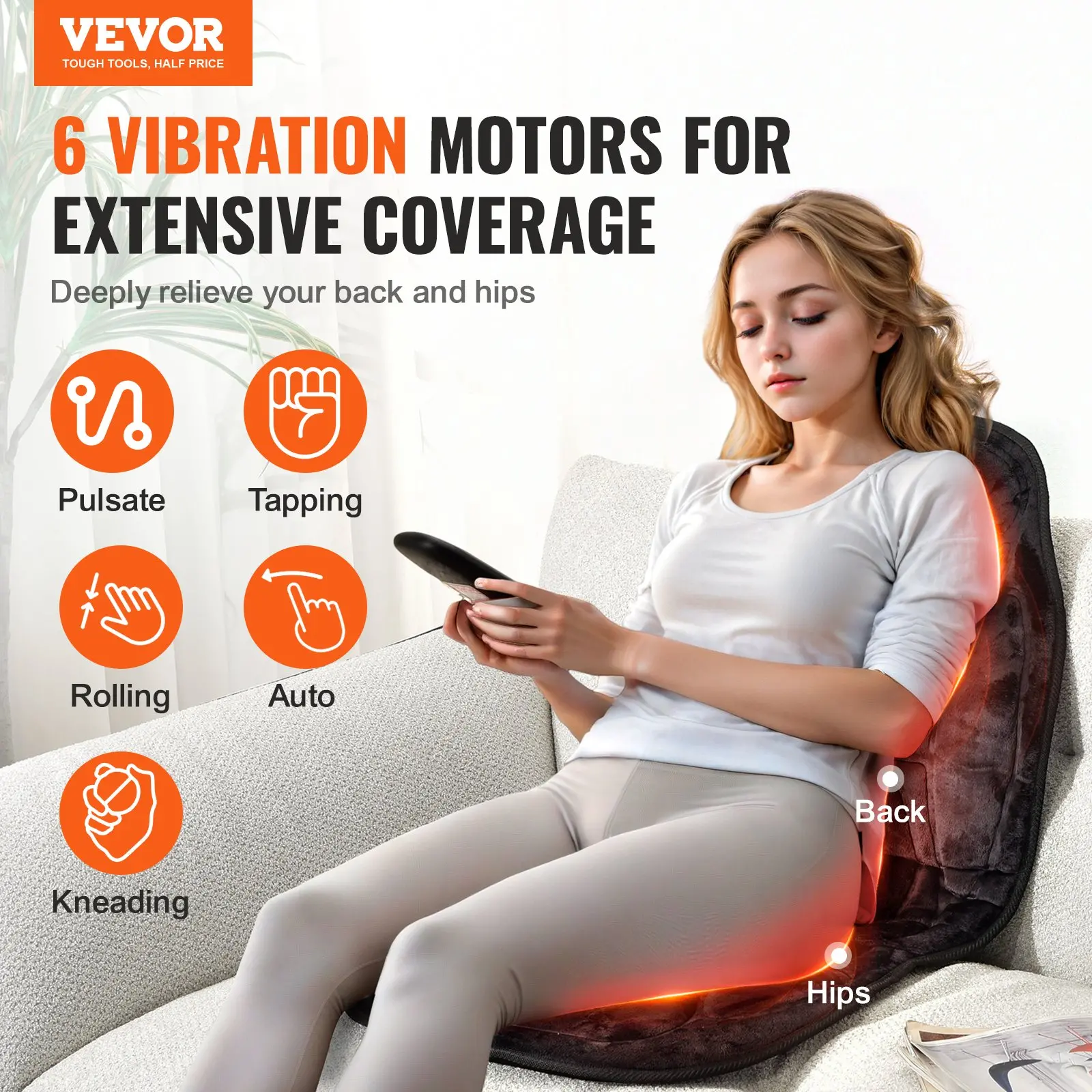 Woman using vibration massage pad on recliner.