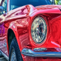 Red classic car headlight close-up