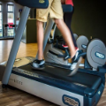 Person running on a treadmill at the gym.