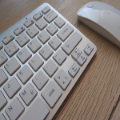 White keyboard and mouse on wooden desk