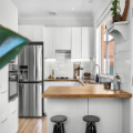 Modern white kitchen with stainless steel appliances