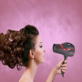 Woman drying curly hair with hairdryer